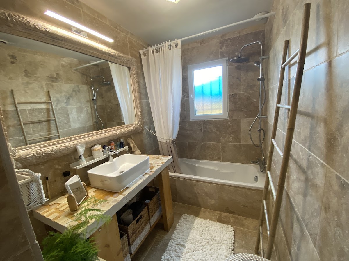 Salle de bain avec baignoire et carrelage pierre — Arnaud Keim